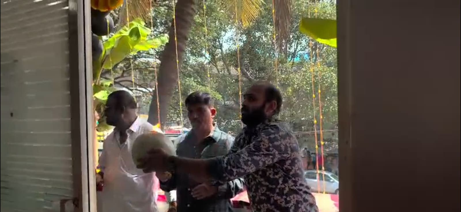 Traditional coconut offering at the decorated entrance of the Sree Ayyappa Tourist office