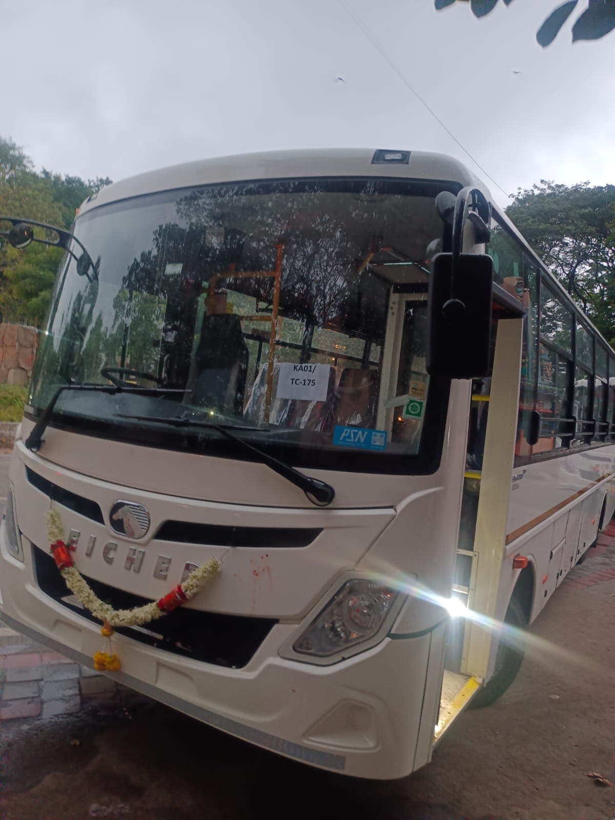 Newly delivered Eicher bus garlanded with flowers before joining the fleet